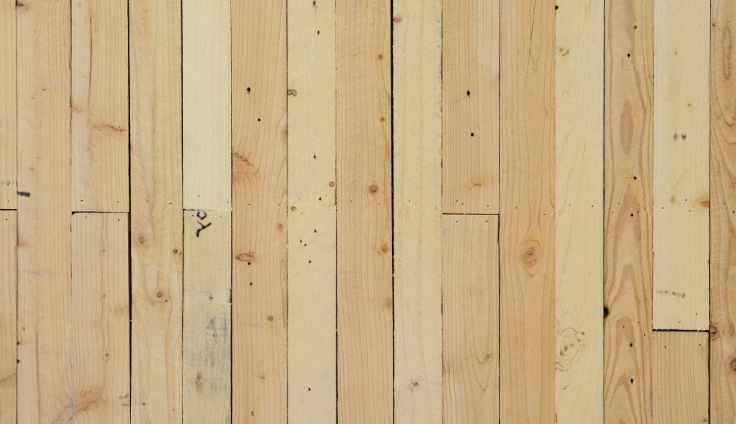 Unfinished tongue and groove flooring boards showing tight timber joints.